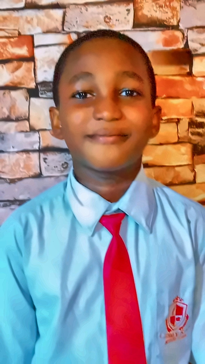 A Junior Secondary School pupil in the school shirt and tie