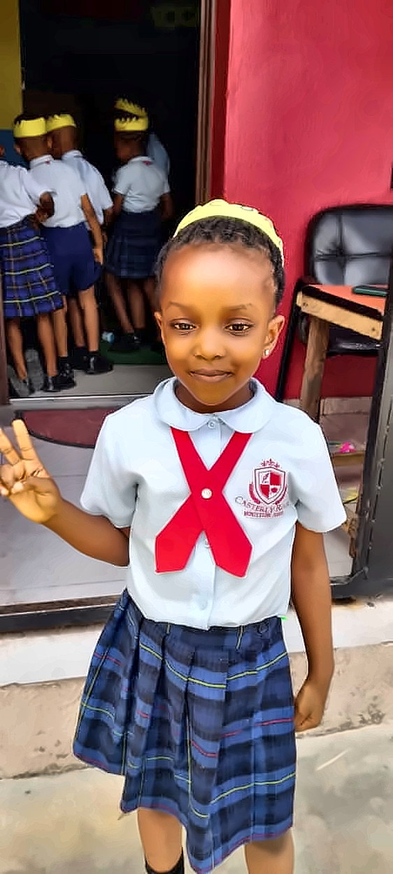 A Casterly Rock pupil in school uniform outside her classroom